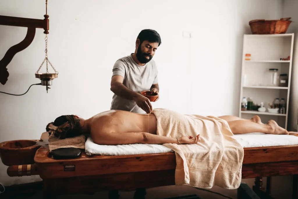 Traditional Udwarthana herbal powder massage for detox and weight loss at Ayurvila Mallorca