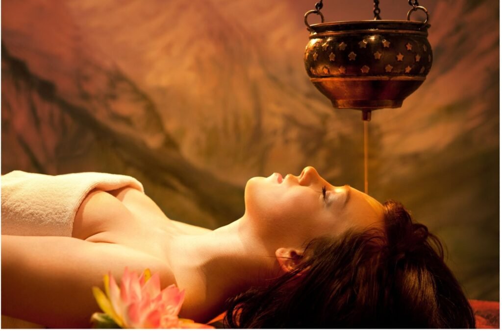 Shirodhara oil flow therapy for stress relief and burnout recovery at Ayurvila retreat